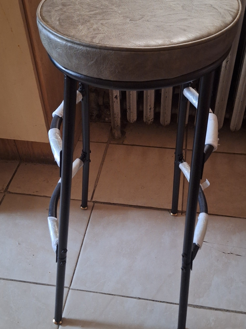 Round Gray Upholstered Bar Stool with Black Metal Frame